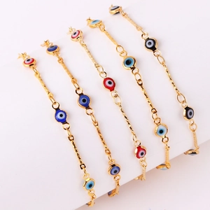 Gold-plated Evil Eye chain necklaces and bracelets with colorful charms on white background