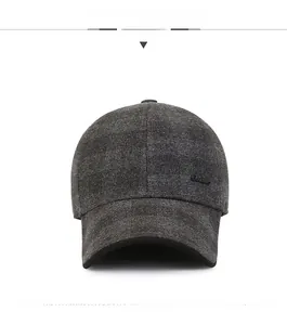 Detailed close-up of dark grey checkered wool texture and brim on a men's baseball cap