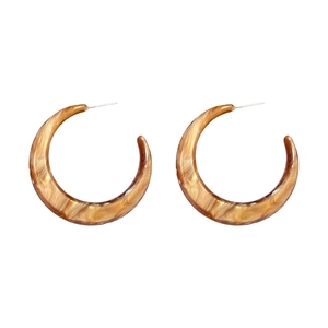 Classic C-shaped tortoise shell resin hoop earrings with marbled brown amber pattern texture