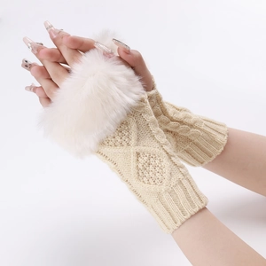 Close-up of knit fingerless gloves with plush faux fur trim and diamond cable texture
