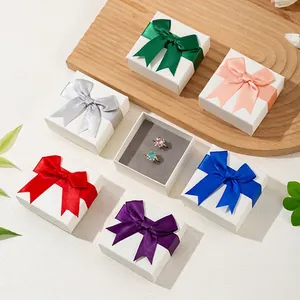 Elegant white jewelry gift boxes with multi-color satin bows and soft flocking inserts