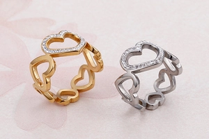 Close-up of hollow heart ring in gold and silver with sparkling cubic zirconia pavé