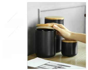 Modern black matte ceramic storage jars with bamboo lids in various sizes for kitchen organization