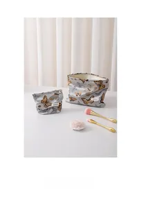 Detail view of vintage butterfly makeup bag set with premium metallic zipper closure