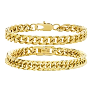 Detail shot of golden cuban link bracelets featuring lobster and fold-over clasps