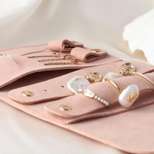 Pink microfiber jewelry roll organizer with necklace slots and soft suede finish