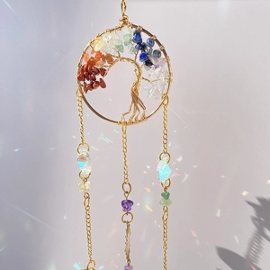 Macro detail of Tree of Life suncatcher with colorful crystals and prism rainbow light