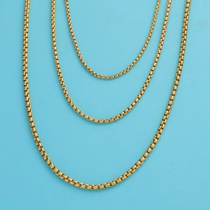 Three gold stainless steel box chains in different lengths on a light blue background