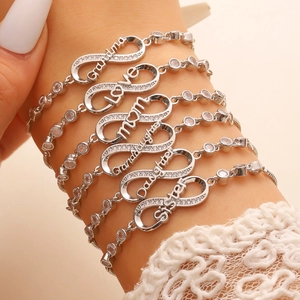 Detail of infinity symbol bracelet set with micro-inlaid zircons on lace sleeve