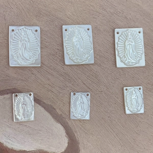 Macro detail of rectangular white mother of pearl Guadalupe pendants for DIY jewelry