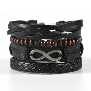 Handmade multilayer leather bracelet set with wooden beads and infinity charm on white background
