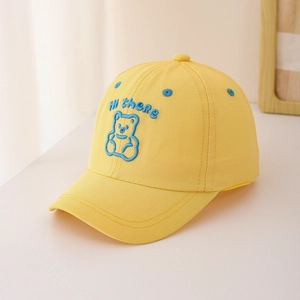 Detailed close-up of yellow cotton child's baseball cap with blue bear embroidery