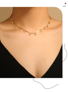 Detailed view of gold sunburst petal charms on a wavy link necklace for women