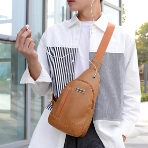 Brown PU leather chest bag for men with red stripe and metal logo plate shown on model