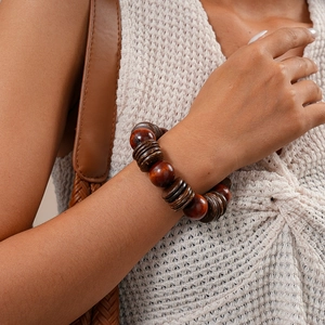 Close-up of vintage wood and coconut shell beads bracelet on a model wrist