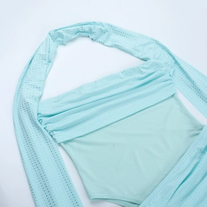 Close-up of mint green halter bodysuit with sparkling silver sequins and matching sleeves
