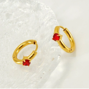 Detail of 18K gold-plated hoop earrings featuring red zircon stones in claw setting