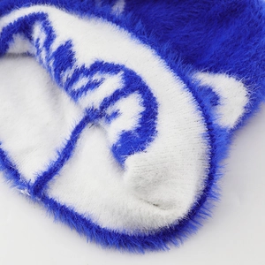 Close-up of soft blue and white long-hair plush knit texture for winter beanies