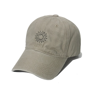 Washed vintage khaki baseball cap with embroidered sun and moon design in front view