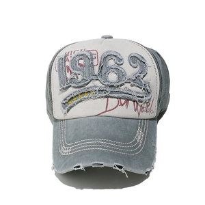 Close-up of vintage 1962 embroidery and distressed details on washed cotton baseball cap