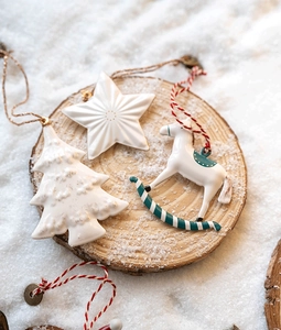 Ceramic Christmas ornaments set with star, tree and horse shapes on wooden base