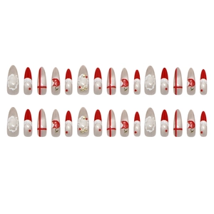 Christmas themed press-on nails with red cat eye patterns and 3D Santa hat almond shape