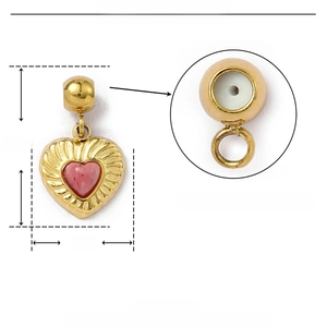 Detailed macro view of heart-shaped gold stainless steel pendant with red natural stone