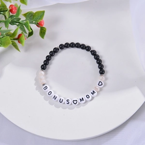 6mm frosted stone bracelet with Bonus Mom letter beads on a white decorative plate
