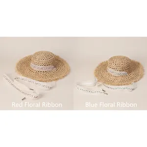 Hollow straw sun hat with raw edges and floral lace ribbon for summer beach vacation