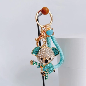 Detailed view of koala keychain with rhinestones, gold plating and braided strap