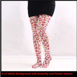 Detail of white printed tights featuring colorful butterflies and floral cherry patterns