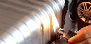 Detail shot showing a flame test on a thick transparent PVC suitcase protective cover