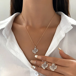 Golden alloy jewelry set with cactus pendants featuring sparkling diamonds and matching earrings