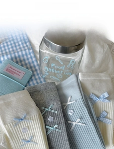 Detailed view of ballet-style crew socks with ribbon bows and floral buttons in soft colors