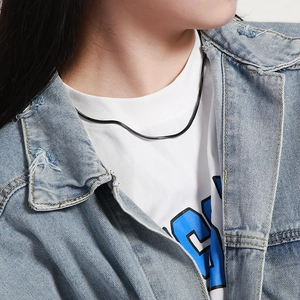 Minimalist black snake chain necklace styled with white tee and denim jacket for fashion