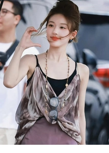 Outdoor street style shot of a woman wearing a round ball crystal picture stone necklace