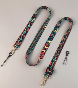Close-up of adjustable crossbody phone strap with colorful geometric totem patterns