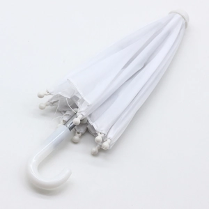 Detailed close-up of a white mini folding umbrella with a curved plastic handle for dolls