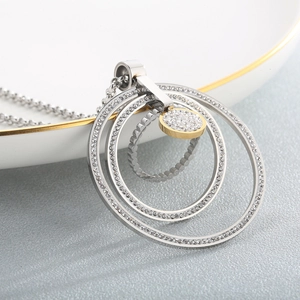 Macro shot of two-tone multi-layered concentric circles pendant with sparkling crystals