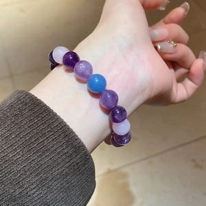 Close-up of natural amethyst, kyanite and rose quartz beaded bracelet on female wrist