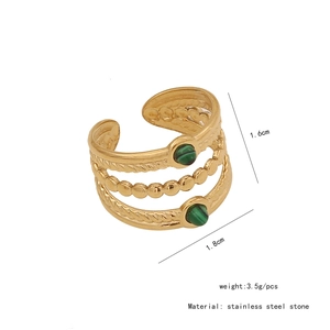 Detail view of vintage gold multilayer ring with green stones and dimensions