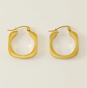 Close-up of gold U-shaped square hoop earrings featuring a brushed matte metallic texture