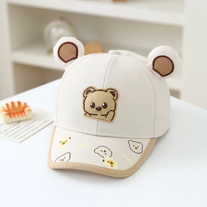 Close-up of cute bear ears and soft rubber badge on the toddler baseball cap brim