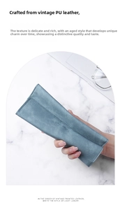 Detail of blue PU leather glasses case with matte texture and minimalist embossed logo