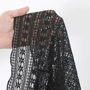Detailed macro view showing the intricate black lace texture and floral jacquard pattern