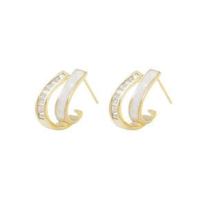 Detailed view of double-layer C-shaped gold earrings with white enamel and square zircons