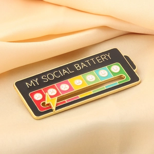 Detail of My Social Battery enamel pin with sliding lightning bolt on silk background
