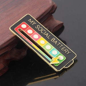 Macro shot of sliding social battery enamel pin with adjustable golden lightning slider