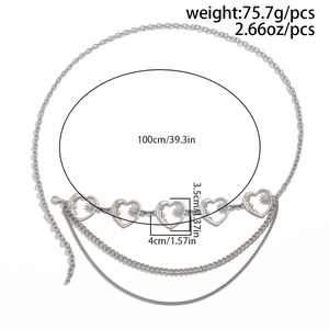 Detail of silver multilayer waist chain with heart links and engraved star patterns