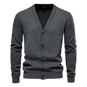 Close-up of dark grey knitted cardigan featuring V-neck and button closure detail